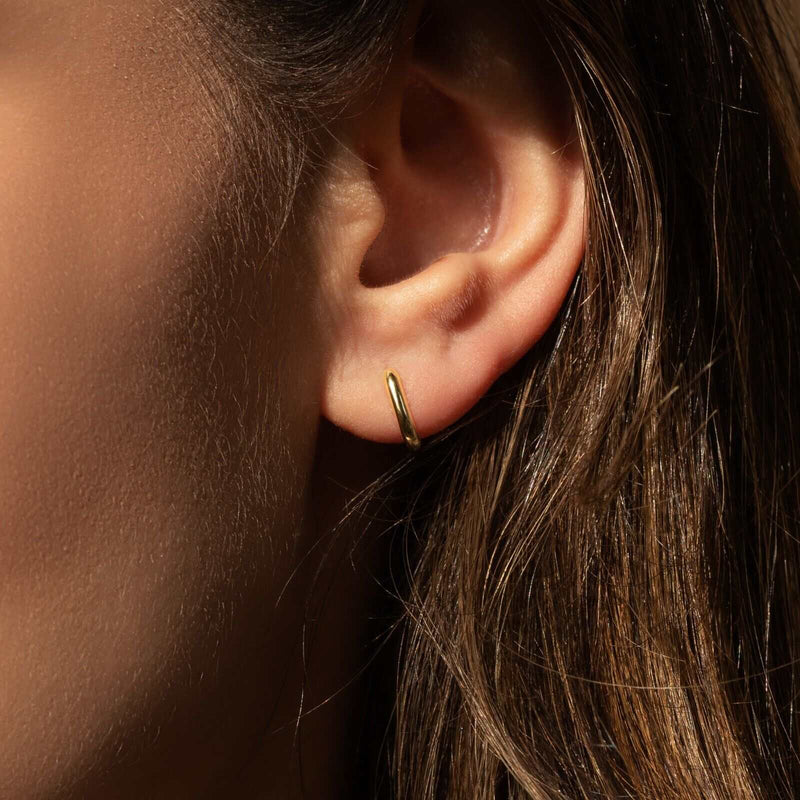 Gold Huggie Earrings in 14K gold and 925 sterling silver for women.