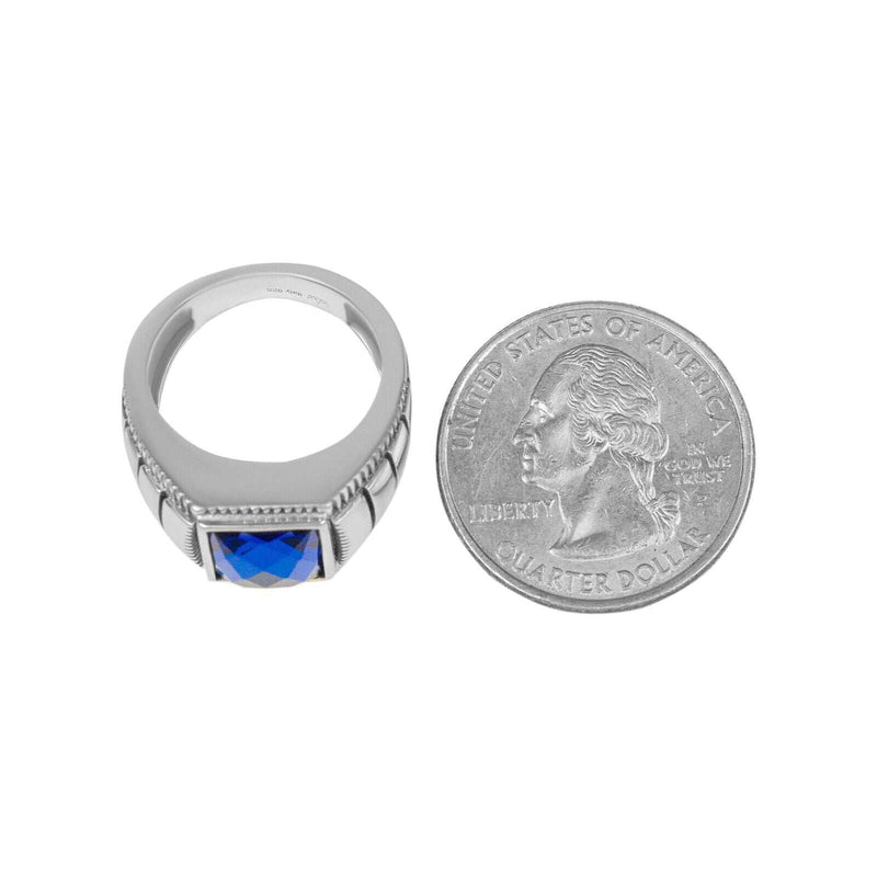 Mens 925 sterling silver ring with blue cubic zirconia stone next to a US quarter.