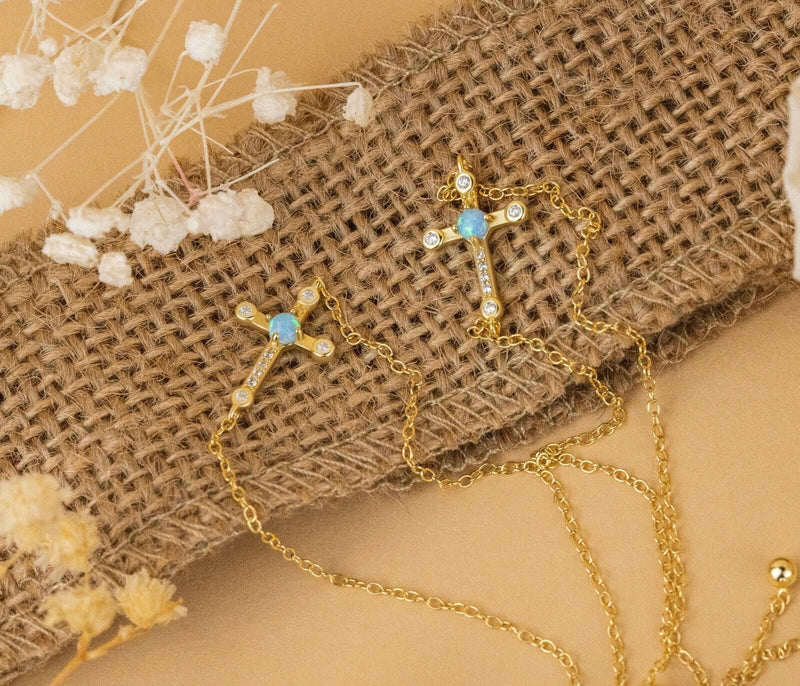 Sterling silver Jesus cross bracelet with 18K gold plating on burlap background.