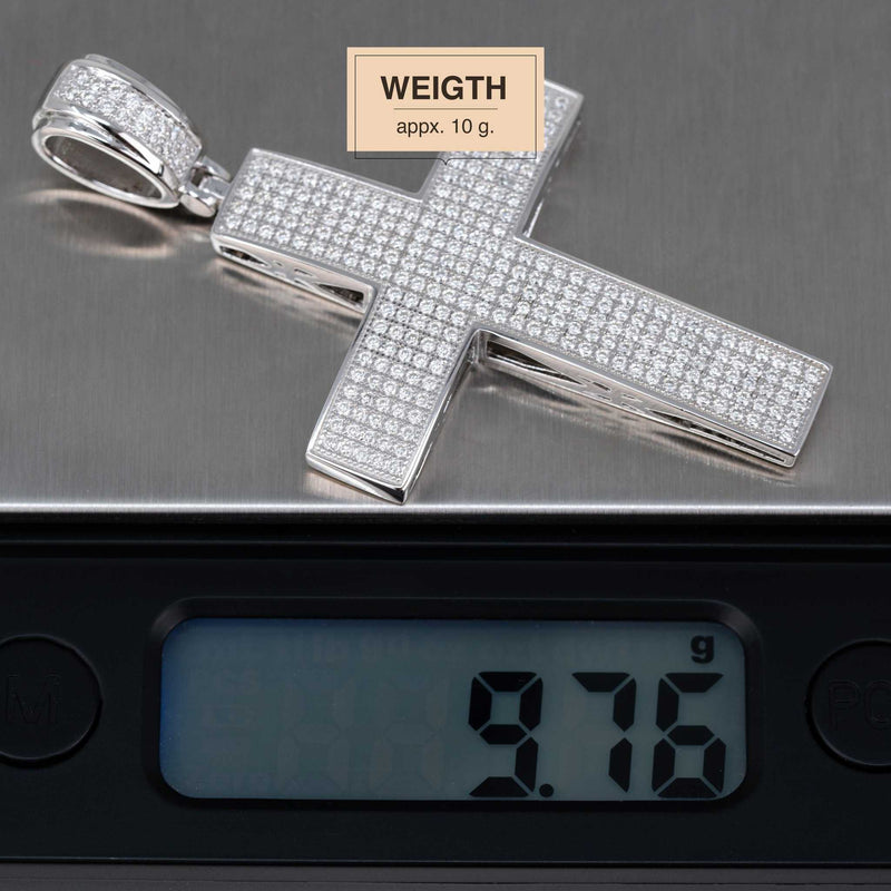 2" Moissanite Cross Pendant in sterling silver with D VVS1 certified round stones on scale, weighing 9.76 grams.