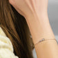 Stars bracelet in 925 sterling silver, 14K gold plated, featuring delicate star charms on wrist.