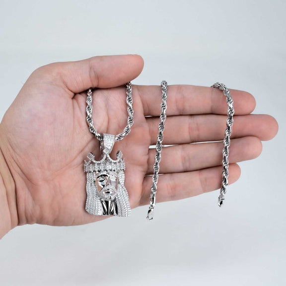 Mens Jesus piece pendant with 4mm rope chain in 925 silver, featuring Moissanite stones, held in hand.