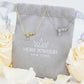 Stars bracelet in 925 sterling silver, 14K gold plated, with tiny charms, displayed on a gift pouch with roses.