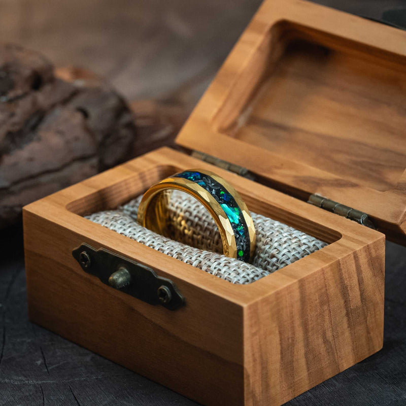 Hammered gold green opal and meteorite tungsten ring in olive wood box.