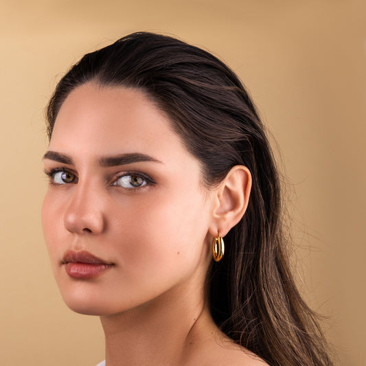 Mirage Gold Hoops on model, 18k PVD gold-plated, hypoallergenic, tarnish-free, and waterproof.