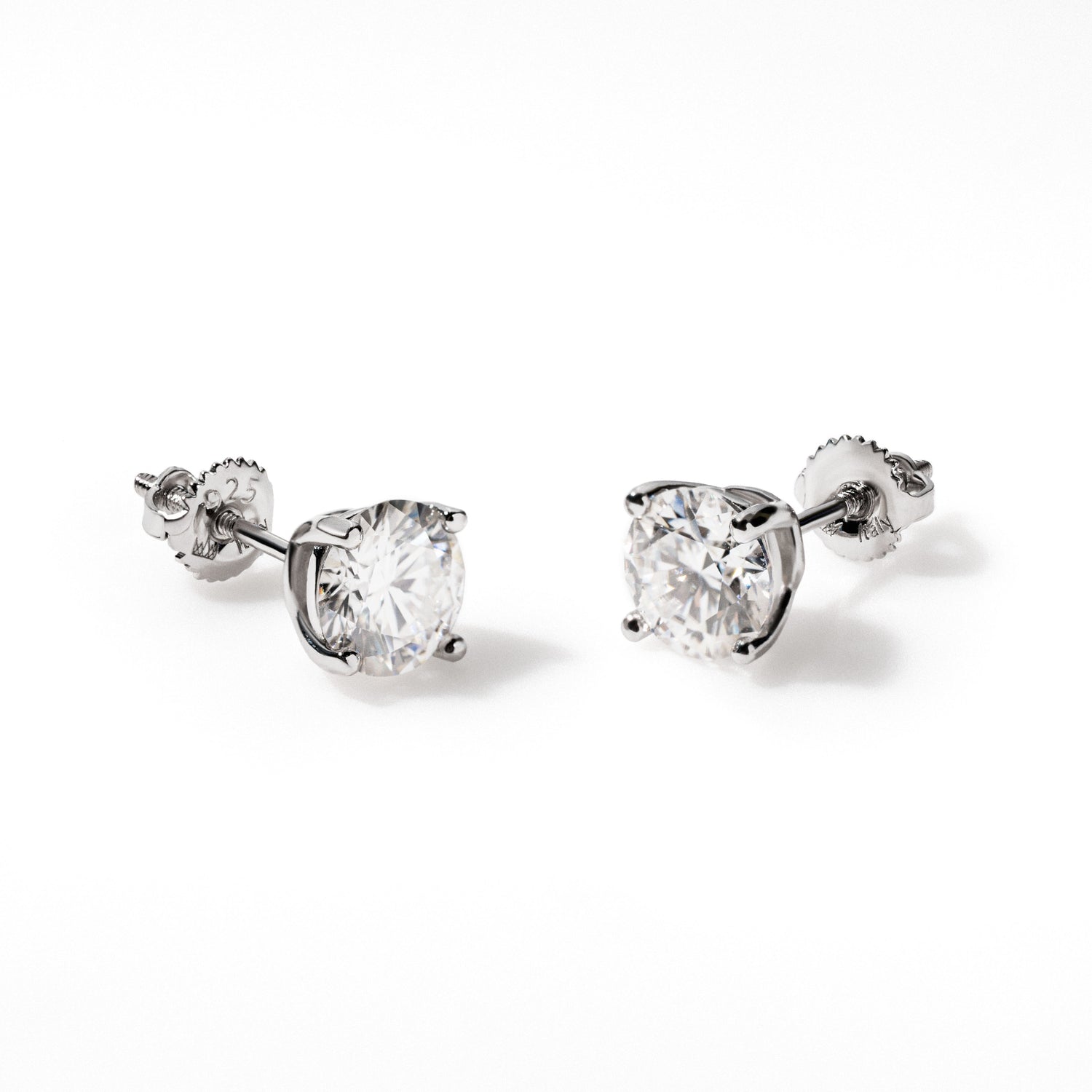 Moissanite stud earrings in 14K white gold plated sterling silver with round cut stones.