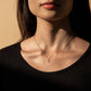 Woman wearing Seashell Serenity Necklace with heart-shaped mother of pearl pendant.